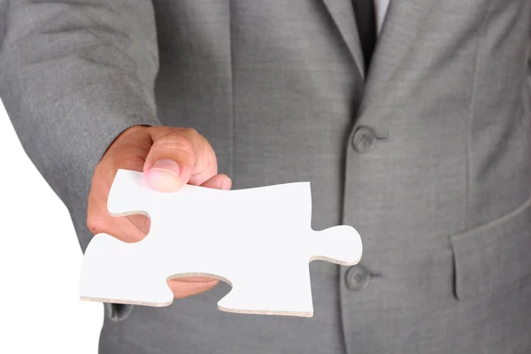 Businessman holding blank jigsaw — Stock Photo, Image