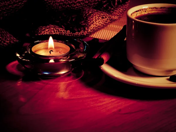 Night background with a cup of coffee, candles and coffee beans — Stock Photo, Image