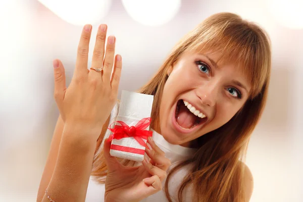 Happy cute girl is showing valentine gift engagement ring on her — Stock Photo, Image