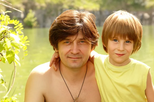 Pai com filho pequeno bonito feliz verão ao ar livre perto do rio — Fotografia de Stock