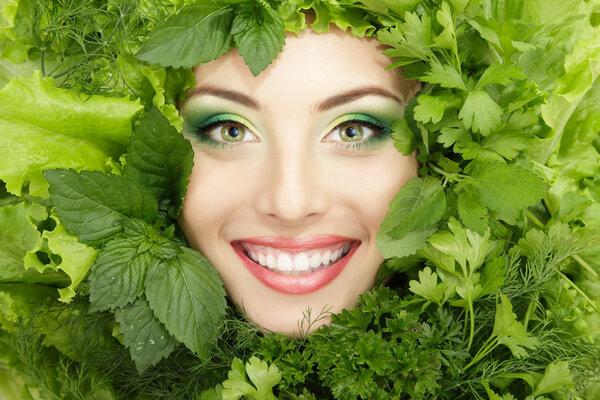 woman beauty face with greens vegetables frame isolated on white