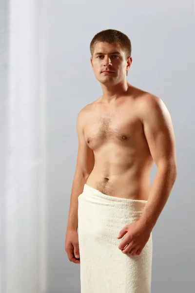 Man young handsome athlete with bath towel — Stock Photo, Image