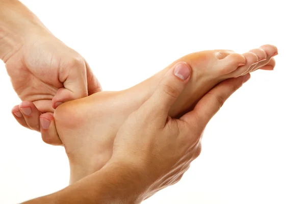 Massage voet vrouwelijke close-up geïsoleerd op wit — Stockfoto