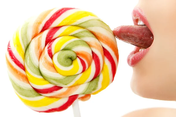 Woman sucking cute sweet candy closeup lips tongue isolated on w — Zdjęcie stockowe