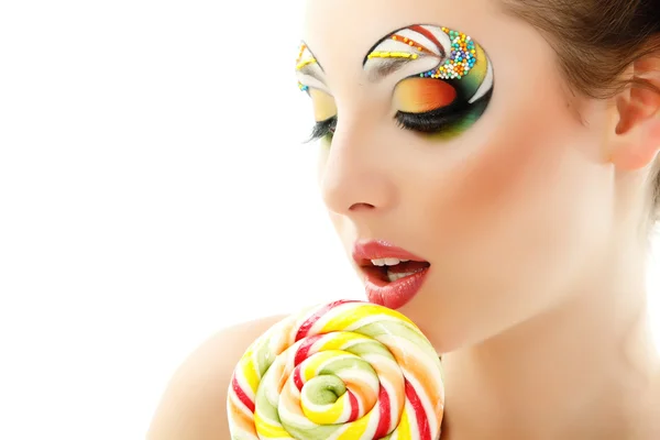 Donna lecca caramelle con bel make-up isolato su bianco — Foto Stock