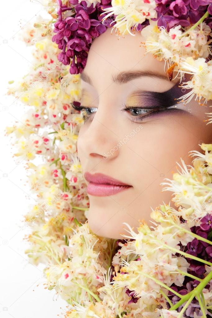 woman beautiful face with flower lilac and chestnut