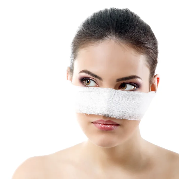 Portrait of beautiful young female face with bandage on her nose — Stock Photo, Image