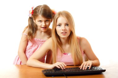 teen and child girls looking with interest in monitor clipart