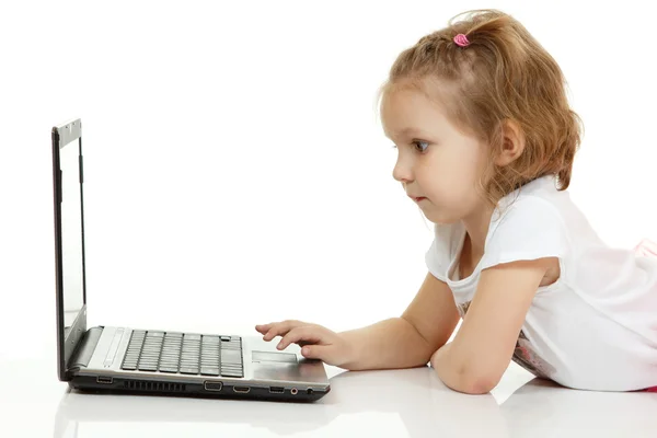 Adorable little girl using laptop — Stock Photo, Image