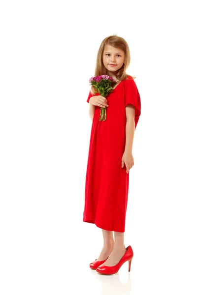 Little fashion girl in mother's red dress and shoe's on high heels — Stock Photo, Image