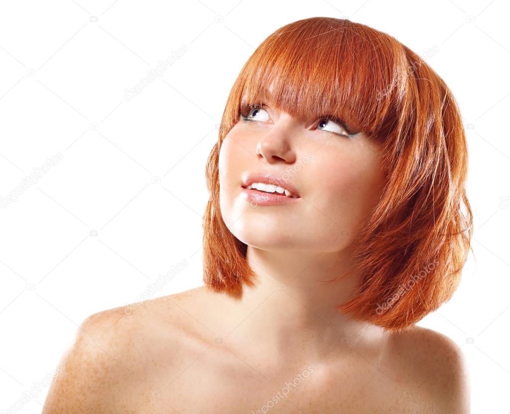 portrait of young beautiful redheaded woman looking up