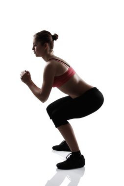 çömelme egzersiz yaparak spor kız