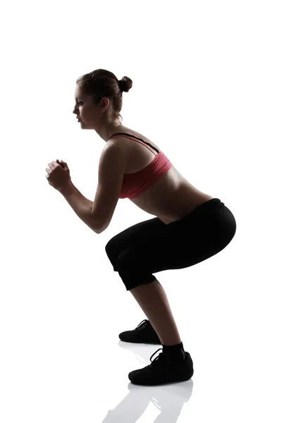 Sport girl doing squatting exercise — Stock Photo, Image
