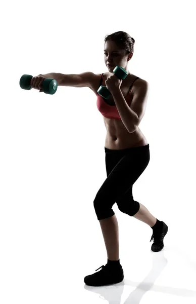 Girl doing hands exercise with dumbbells — Stock Photo, Image