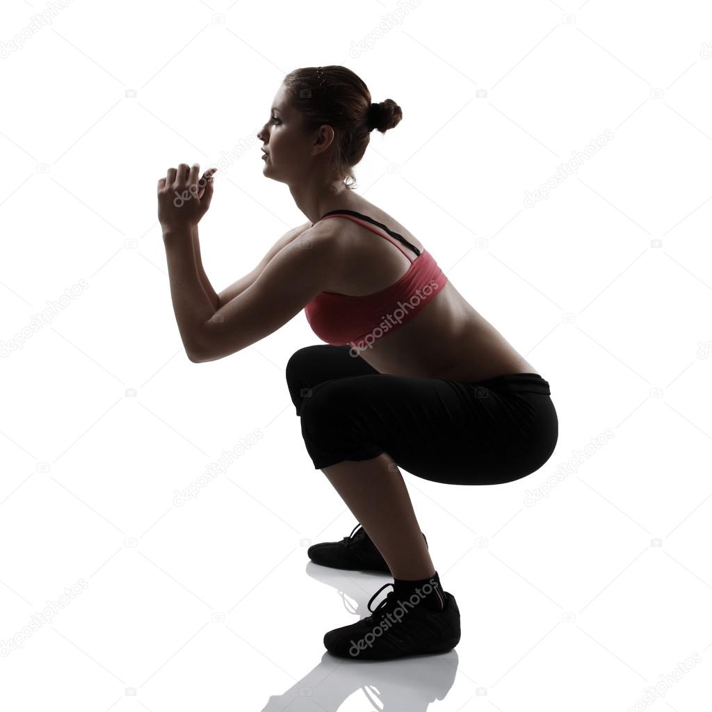 Sport girl doing squatting exercise