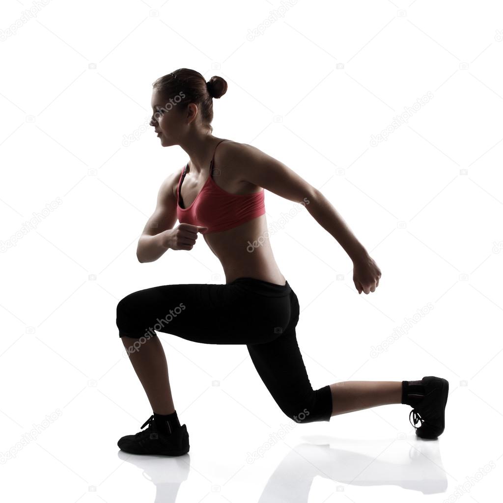 Athletic woman doing lunge