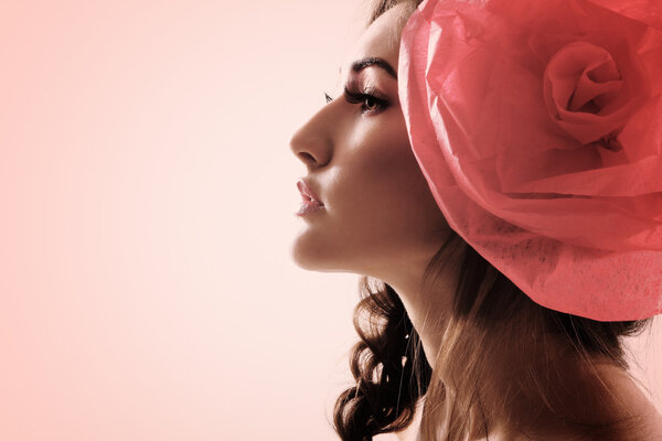 Vintage portrait of fashion glamour girl with red flower in her hair