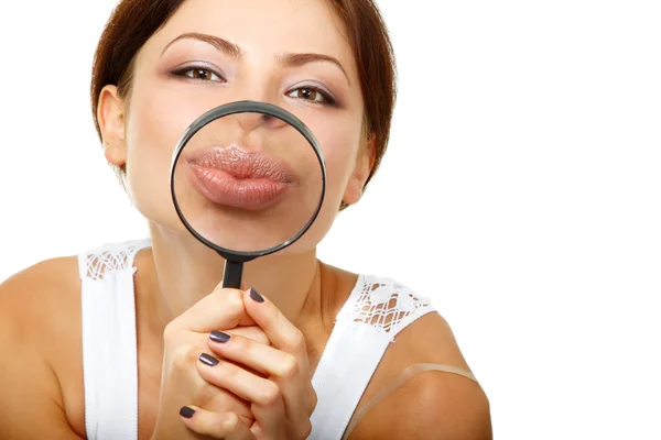 Woman give kiss through a magnifying glass — Stock Photo, Image