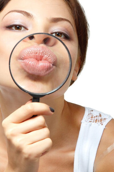 Woman give kiss through a magnifying glass