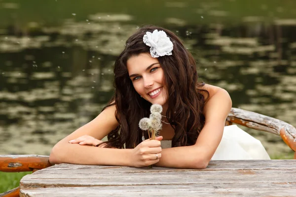 Vrouw met paardebloemen zomer — Stockfoto