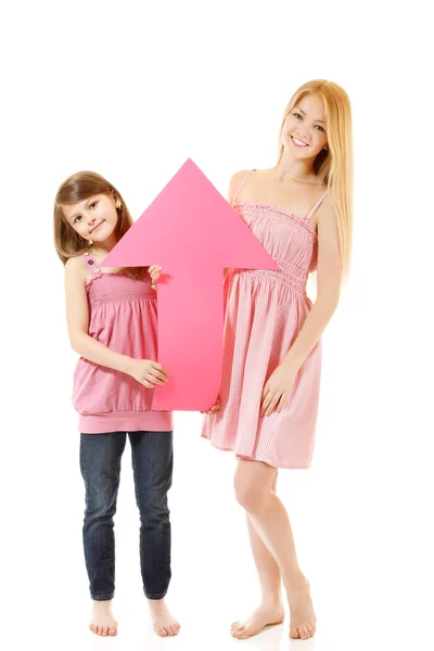 Sisters smiling hplding pink arrow — Stock Photo, Image