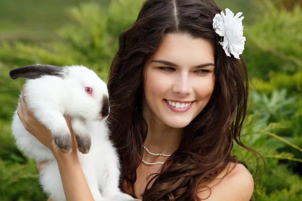 Невеста улыбается и держит милого кролика — стоковое фото