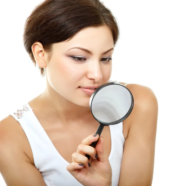 Woman looking through a magnifying glass Stock Photo