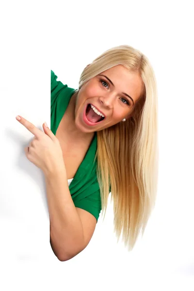 Young happy woman pointing at something — Stock Photo, Image