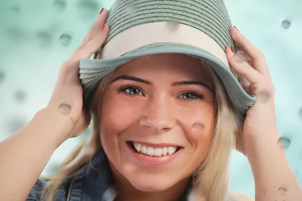 Kvinna som håller sin hatt i regnet — Stockfoto