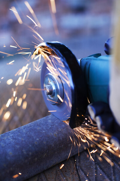 Angle grinder cutting steel