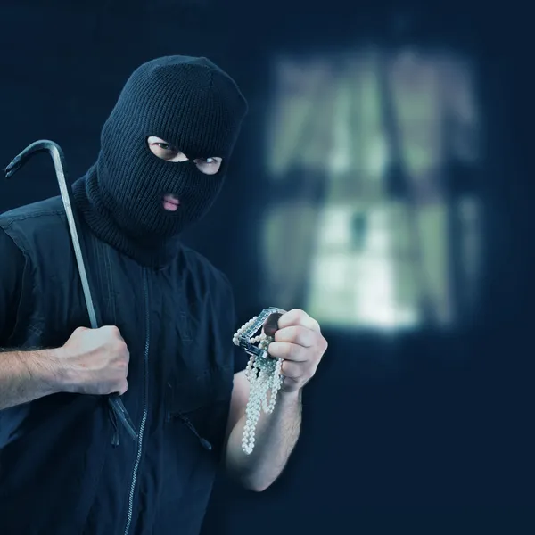 Masked thief stealing jewelry — Stock Photo, Image