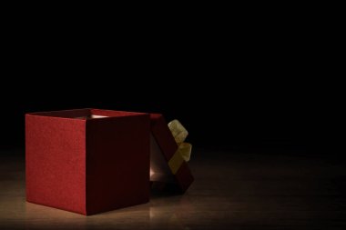 Koyu arka plan üzerinde kırmızı hediye kutusu