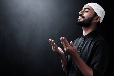 Dindar Asyalı Müslüman adam dua ediyor.