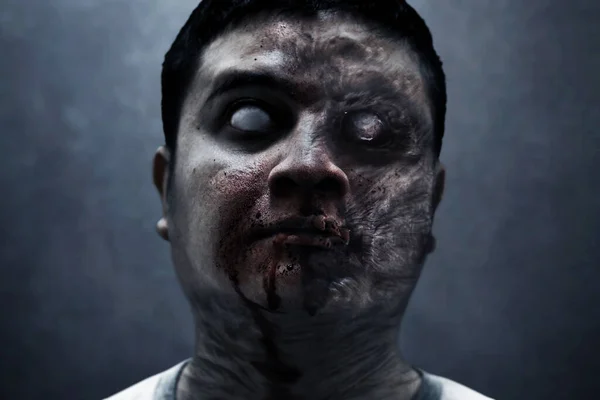 Scary zombie man on dark background