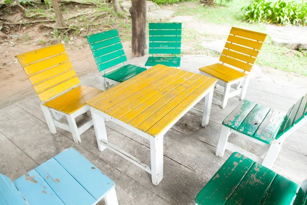 Multi-colored wooden table and chairs. — Stock Photo, Image