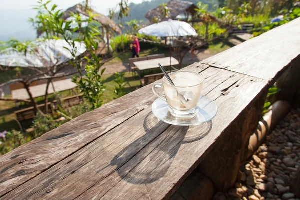 Coffee laid on wooden terrace — Stock Photo, Image