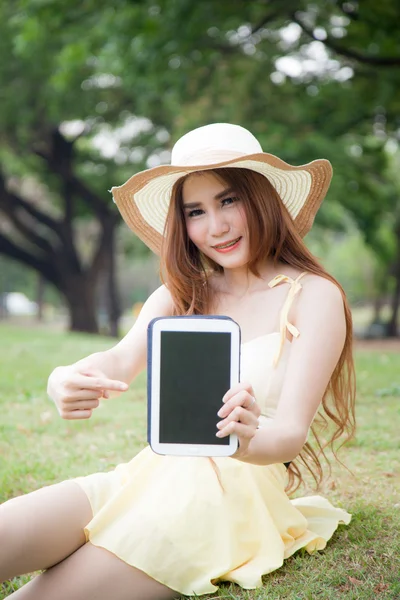 Asijské ženy podala tabletu a ukázal na tabletu. — Stock fotografie