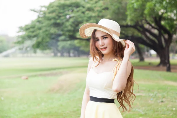 Mulher usando um chapéu no parque . — Fotografia de Stock