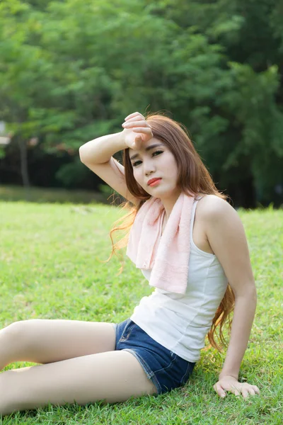 Woman sitting tired after jogging. — Stock Photo, Image