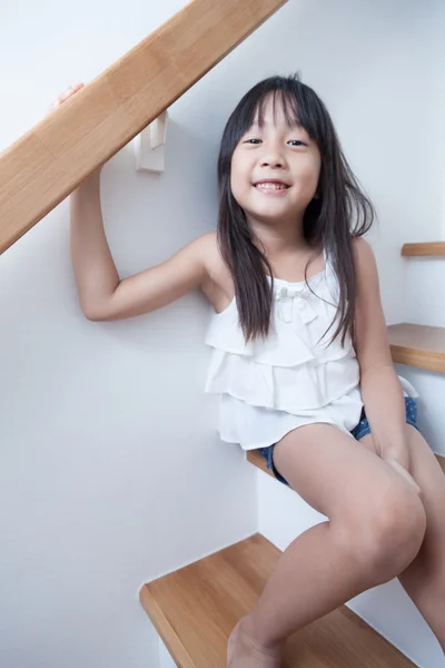 Girl sitting in on the ladder — Stock Photo, Image