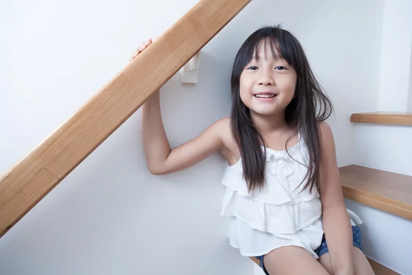 Girl sitting in on the ladder — Stock Photo, Image