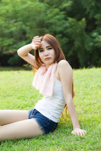 Woman sitting tired after jogging. — Stock Photo, Image