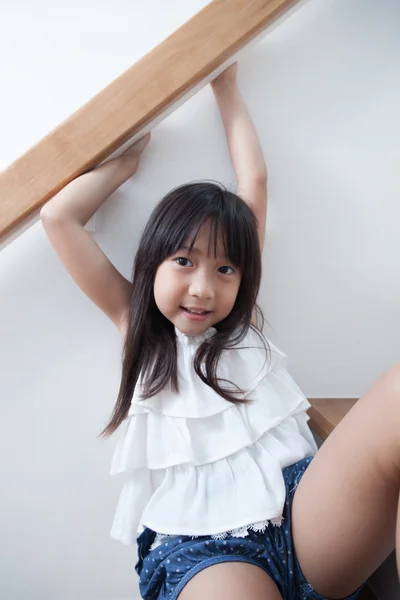 Girl sitting in on the ladder — Stock Photo, Image