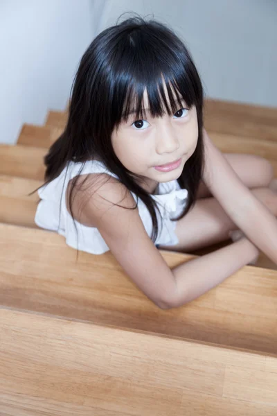 Girl sitting in on the ladder — Stock Photo, Image