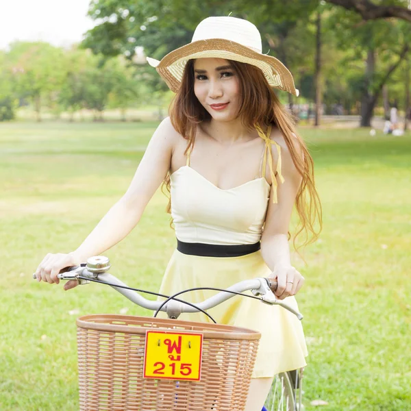 Mulher asiática montando uma bicicleta — Fotografia de Stock