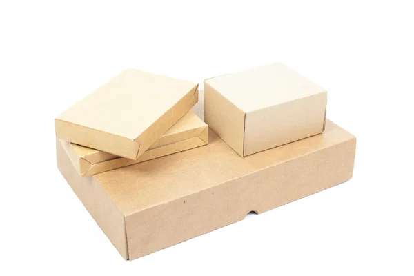Small brown cardboard boxes stacked on top large box. — Stock Photo, Image