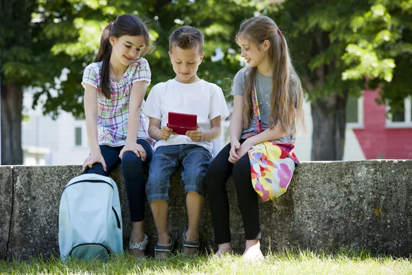 Niños jugando videojuegos al aire libre — Foto de Stock