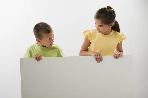 Two children holding a blank sign — Stock Photo, Image
