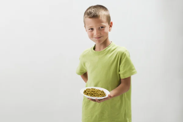 Little boy with peas — Stock Photo, Image