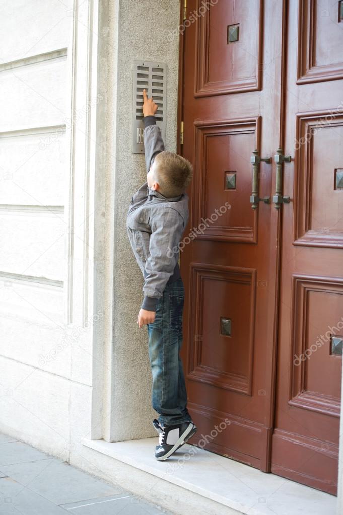 Boy ringing doorbell